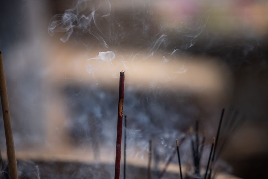 Peaceful incense sticks with smoke rising, captured at a temple in Seruwawila, Sri Lanka.
