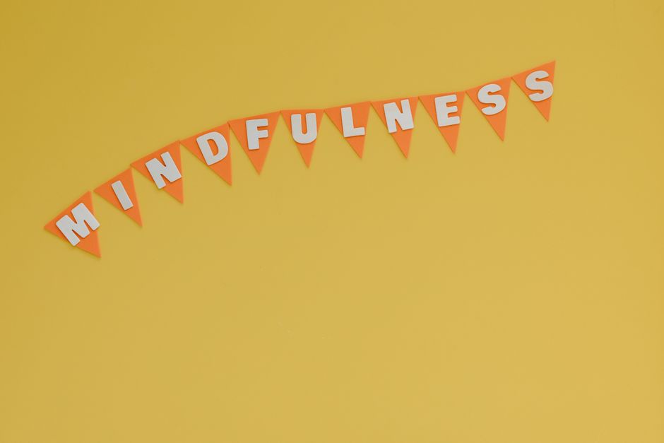 Banner with 'Mindfulness' on a bright yellow background, symbolizing calm and focus.